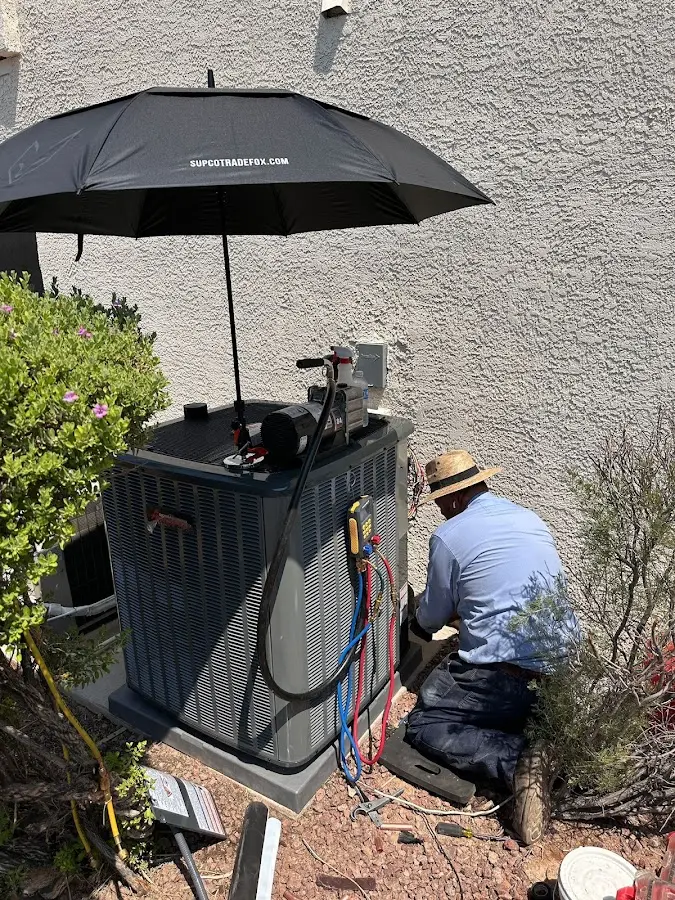 HVAC technician performing outdoor AC maintenance in Hastings